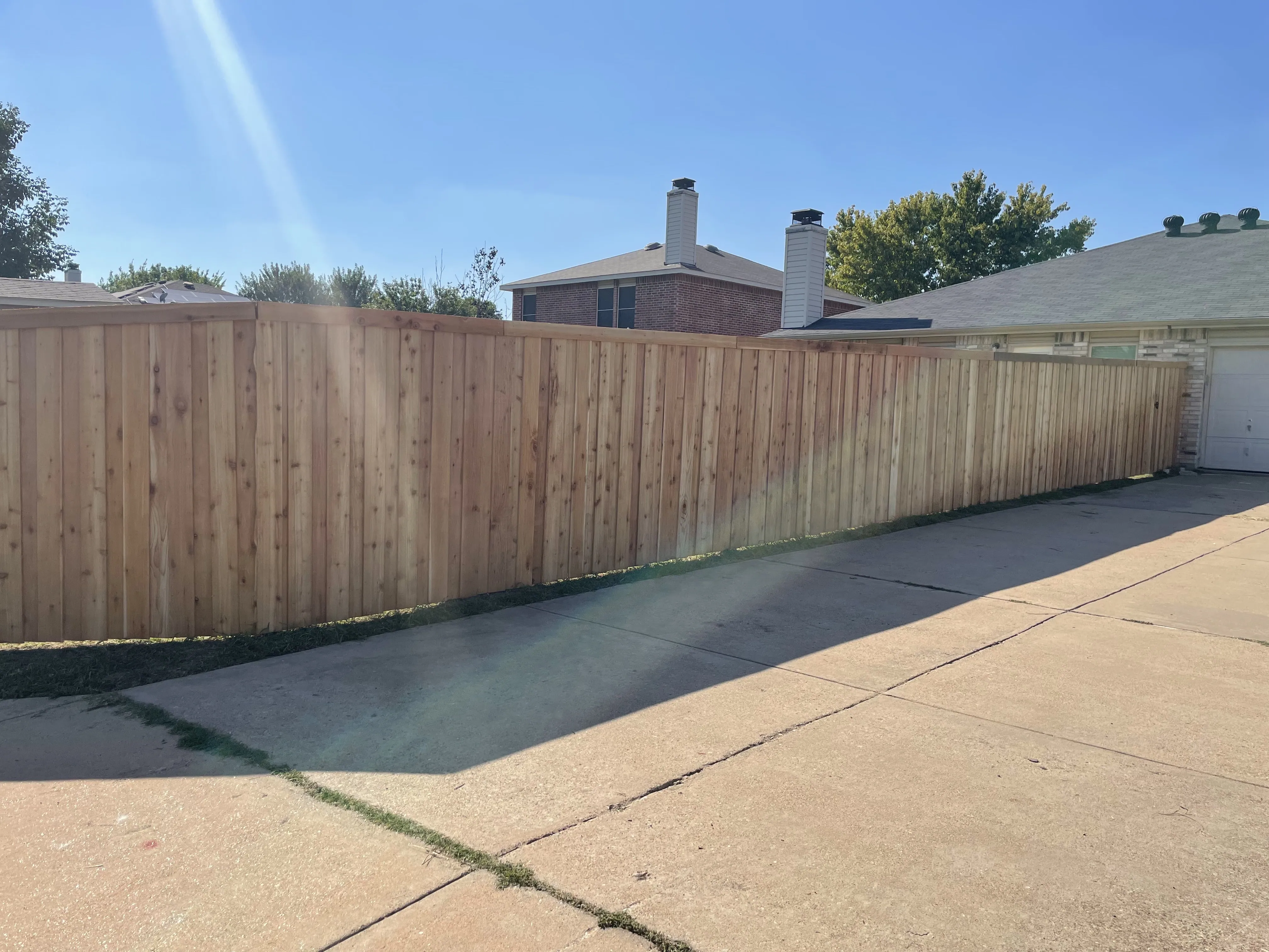 Driveway view of newly installed fence in Euless, TX